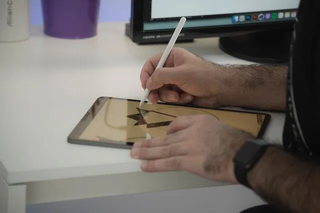 Man designing a business logo on tablet