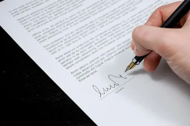 Man signing an important document